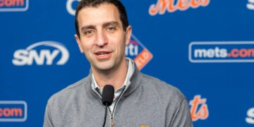 David Stearns speaks into a microphone at a press conference.