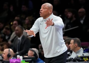 Doc Rivers shouting and gesturing during a basketball game.