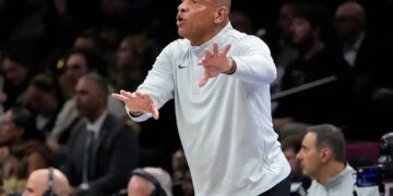 Doc Rivers shouting and gesturing during a basketball game.