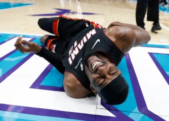 Heat center Bam Adebayo writhes in pain after getting tripped by the Hornets' LaMelo Ball in the second quarter on April 14, 2026.