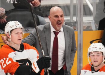 Philadelphia Flyers head coach Rick Tocchet yelling from the bench during a hockey game.