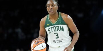 Seattle Storm forward Nneka Ogwumike dribbling a basketball.