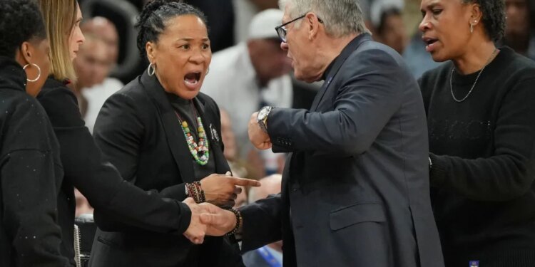 South Carolina head coach Dawn Staley, left, and UConn head coach Geno Auriemma argue after a woman's NCAA college basketball tournament semifinal game at the Final Four, Friday, April 3, 2026, in Phoenix.