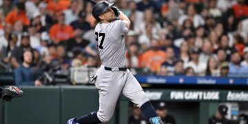 New York Yankees designated hitter Giancarlo Stanton (27) hits the ball in the third inning against the Houston Astros at Daikin Park.
