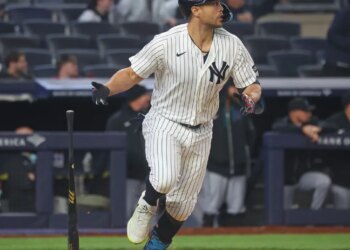 New York Yankees designated hitter Giancarlo Stanton hits a single during the 7th inning.