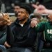 Milwaukee Bucks' Giannis Antetokounmpo gestures from the bench.