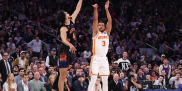 Atlanta Hawks guard CJ McCollum #3 puts up a shot as New York Knicks guard Landry Shamet #44 jumps to defend during the first quarter.
