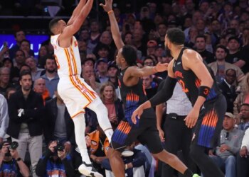 Atlanta Hawks guard CJ McCollum #3 puts up a shot over New York Knicks forward Og Anunoby #8 during the fourth quarter.