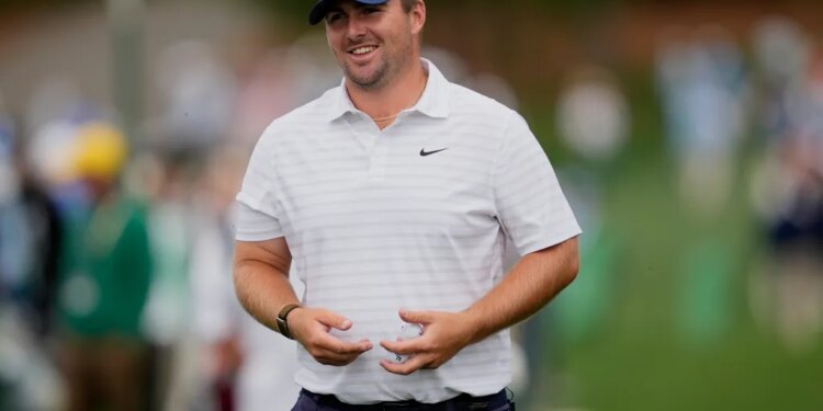 Golfer Scott Stallings smiling and holding a golf ball.