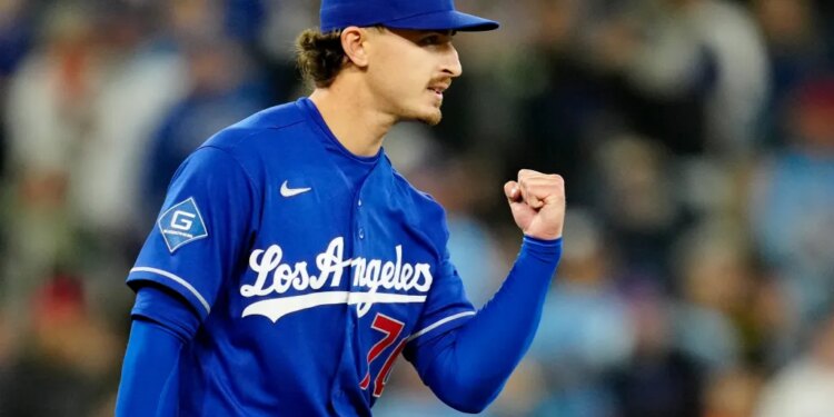Justin Wrobleski in a blue Los Angeles Dodgers uniform with a raised fist.