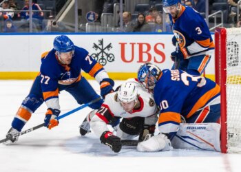 New York Islanders defenseman Tony DeAngelo (77) checks Ottawa Senators center Ridly Greig (71) during the second period at UBS Arena, Saturday, April 11, 2026, in Elmont, NY.