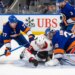 New York Islanders defenseman Tony DeAngelo (77) checks Ottawa Senators center Ridly Greig (71) during the second period at UBS Arena, Saturday, April 11, 2026, in Elmont, NY.