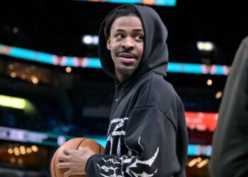 Memphis Grizzlies guard Ja Morant stands on the court before an NBA basketball game.