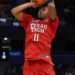 A Texas Tech basketball player in a red jersey with number 11 shoots a basketball.