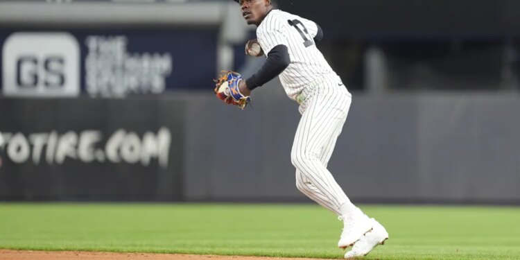 New York Yankees second baseman Jazz Chisholm Jr. (13) throws a baseball during the sixth inning at Yankee Stadium.