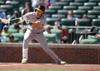 Jeff McNeil (22) hits the ball into the glove of catcher Drake Baldwin for a strikeout in the ninth inning of Athletics' 5-1 loss to the Braves on April 1, 2026.