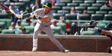 Jeff McNeil (22) hits the ball into the glove of catcher Drake Baldwin for a strikeout in the ninth inning of Athletics' 5-1 loss to the Braves on April 1, 2026.