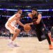 New York Knicks center Karl-Anthony Towns (32) drives to the basket against an Atlanta Hawks player.