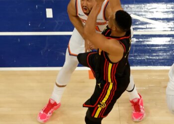 Atlanta Hawks guard CJ McCollum (3) puts up a shot and kicks New York Knicks guard Jalen Brunson (11) in the groin during the third quarter.