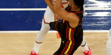 Atlanta Hawks guard CJ McCollum (3) puts up a shot and kicks New York Knicks guard Jalen Brunson (11) in the groin during the third quarter.