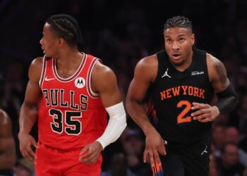 Miles McBride of the New York Knicks (right) and a Chicago Bulls player (left) on the court during an NBA game.
