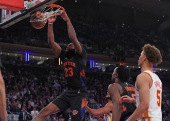 New York Knicks center Mitchell Robinson #23 dunks the ball during a game against the Atlanta Hawks.