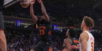 New York Knicks center Mitchell Robinson #23 dunks the ball during a game against the Atlanta Hawks.