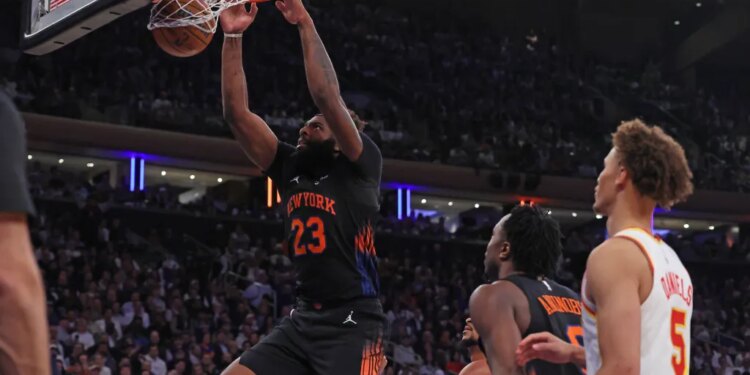 New York Knicks center Mitchell Robinson #23 dunks the ball during a game against the Atlanta Hawks.