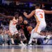 New York Knicks guard Jalen Brunson #11 drives to the basket between Atlanta Hawks forward Mouhamed Gueye #18 and Atlanta Hawks guard CJ McCollum #3.