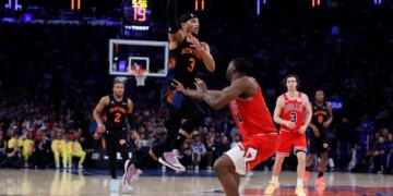 Guard Josh Hart #3 of the New York Knicks makes a jumping pass over forward Patrick Williams #44 of the Chicago Bulls during the first half at Madison Square Garden, Friday April 3rd, 2026, in New York, NY.