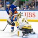 Kyle Palmieri #21 of the New York Islanders watches as Jeremy Swayman #1 of the Boston Bruins makes a glove save during the third period at UBS Arena, Wednesday, Nov. 26, 2025, in Elmont, NY.