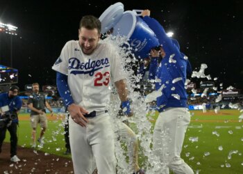 Los Angeles Dodgers right fielder Kyle Tucker (23) is doused with ice water from a cooler by right fielder Alex Call (12) after Tucker's walk-off single.
