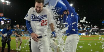 Los Angeles Dodgers right fielder Kyle Tucker (23) is doused with ice water from a cooler by right fielder Alex Call (12) after Tucker's walk-off single.