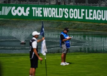 A caddie studies the putting green at the 18th hole during the first round of the LIV Golf tournament in Naucalpan on the outskirts of Mexico City.