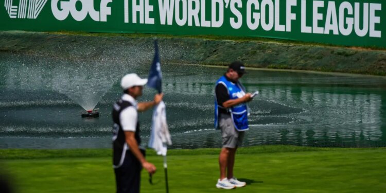 A caddie studies the putting green at the 18th hole during the first round of the LIV Golf tournament in Naucalpan on the outskirts of Mexico City.
