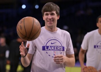 NBA player Austin Reaves of the Los Angeles Lakers dribbles a basketball.