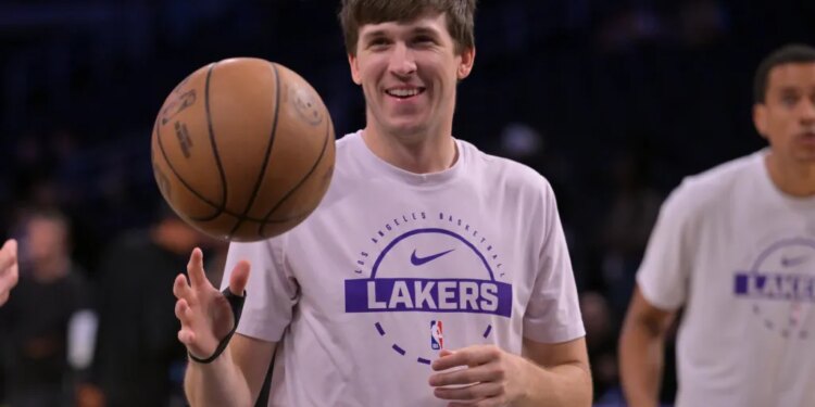 NBA player Austin Reaves of the Los Angeles Lakers dribbles a basketball.