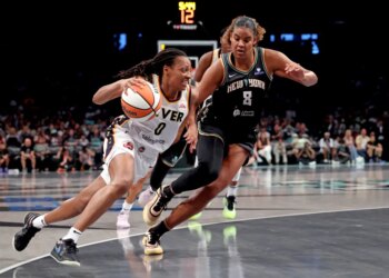 Kelsey Mitchell #0 of the Indiana Fever drives to the basket as Nyara Sabally #8 of the New York Liberty gives chase during the second quarter.