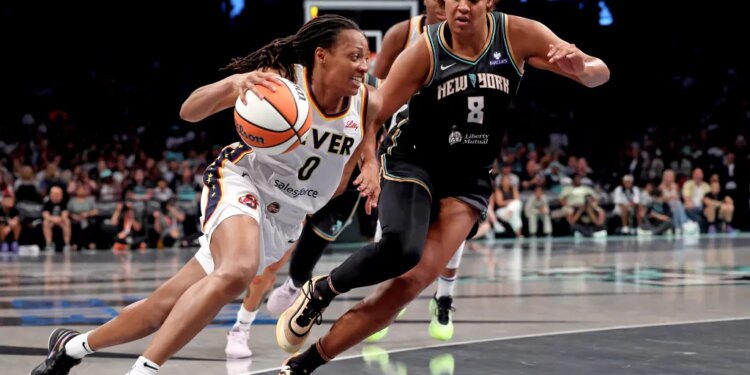 Kelsey Mitchell #0 of the Indiana Fever drives to the basket as Nyara Sabally #8 of the New York Liberty gives chase during the second quarter.