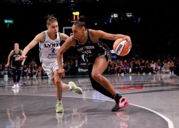 Betnijah Laney-Hamilton of the New York Liberty drives with the basketball, defended by Natisha Hiedeman of the Minnesota Lynx, during Game 5 of the 2024 WNBA Finals.