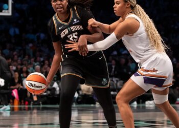 Jonquel Jones dribbling past Satou Sabally during a basketball game.