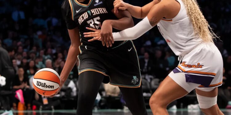 Jonquel Jones dribbling past Satou Sabally during a basketball game.