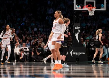 Satou Sabally of the Phoenix Mercury reacting to a shot over Emma Meesseman of the New York Liberty during a WNBA playoffs game.