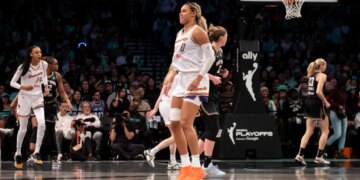 Satou Sabally of the Phoenix Mercury reacting to a shot over Emma Meesseman of the New York Liberty during a WNBA playoffs game.