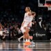 Satou Sabally of the Phoenix Mercury reacting to a shot over Emma Meesseman of the New York Liberty during a WNBA playoffs game.