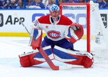 Montreal Canadiens goaltender Jakub Dobes (75) guards the goal during a game against the Tampa Bay Lightning.