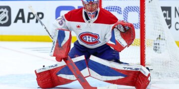 Montreal Canadiens goaltender Jakub Dobes (75) guards the goal during a game against the Tampa Bay Lightning.