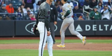 New York Mets pitcher Luke Weaver reacts as Athletics left fielder Tyler Soderstrom rounds the bases after hitting a three-run home run.