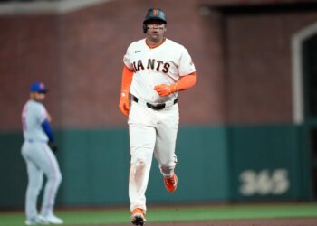 Rafael Devers of the San Francisco Giants rounding the bases after hitting a solo home run.