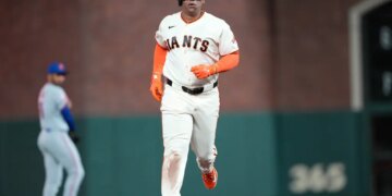 Rafael Devers of the San Francisco Giants rounding the bases after hitting a solo home run.